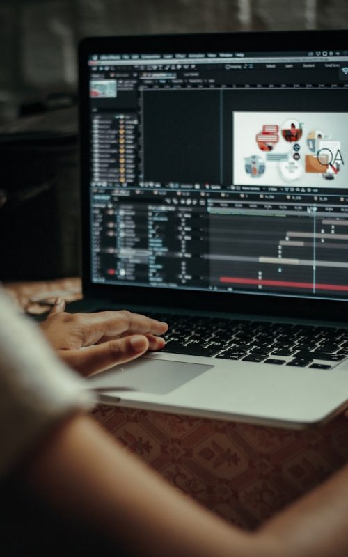 person using macbook pro on table